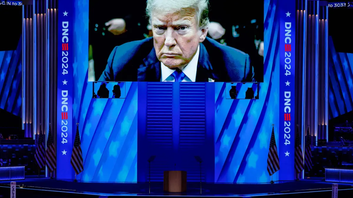 2024 Democratic National Convention: Day 1: CHICAGO, ILLINOIS - AUGUST 19: A video featuring a courtroom photo of Republican presidential candidate former President Donald Trump plays during the first day of the Democratic National Convention at the United Center on August 19, 2024 in Chicago, Illinois. Delegates, politicians, and Democratic party supporters are in Chicago for the convention, concluding with current Vice President Kamala Harris accepting her party's presidential nomination. The DNC takes place from August 19-22. Chip Somodevilla/Getty Images/AFP (Photo by CHIP SOMODEVILLA / GETTY IMAGES NORTH AMERICA / Getty Images via AFP)