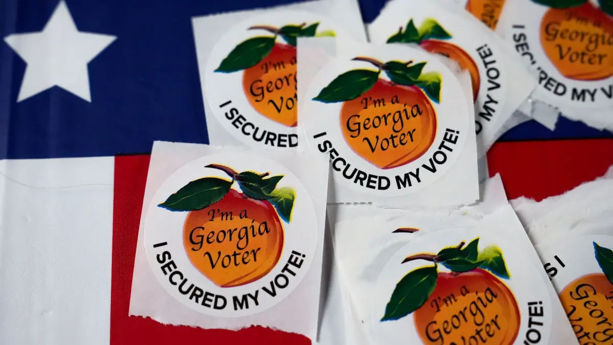 US-Wahlen 2024 - Georgia: 05.11.2024, USA, Atlanta: Aufkleber mit der Aufschrift "Ich bin ein Wähler aus Georgia. Ich habe mir meine Stimme gesichert." liegen auf einem Tisch in einem Wahllokal. Foto: Brynn Anderson/AP +++ dpa-Bildfunk +++