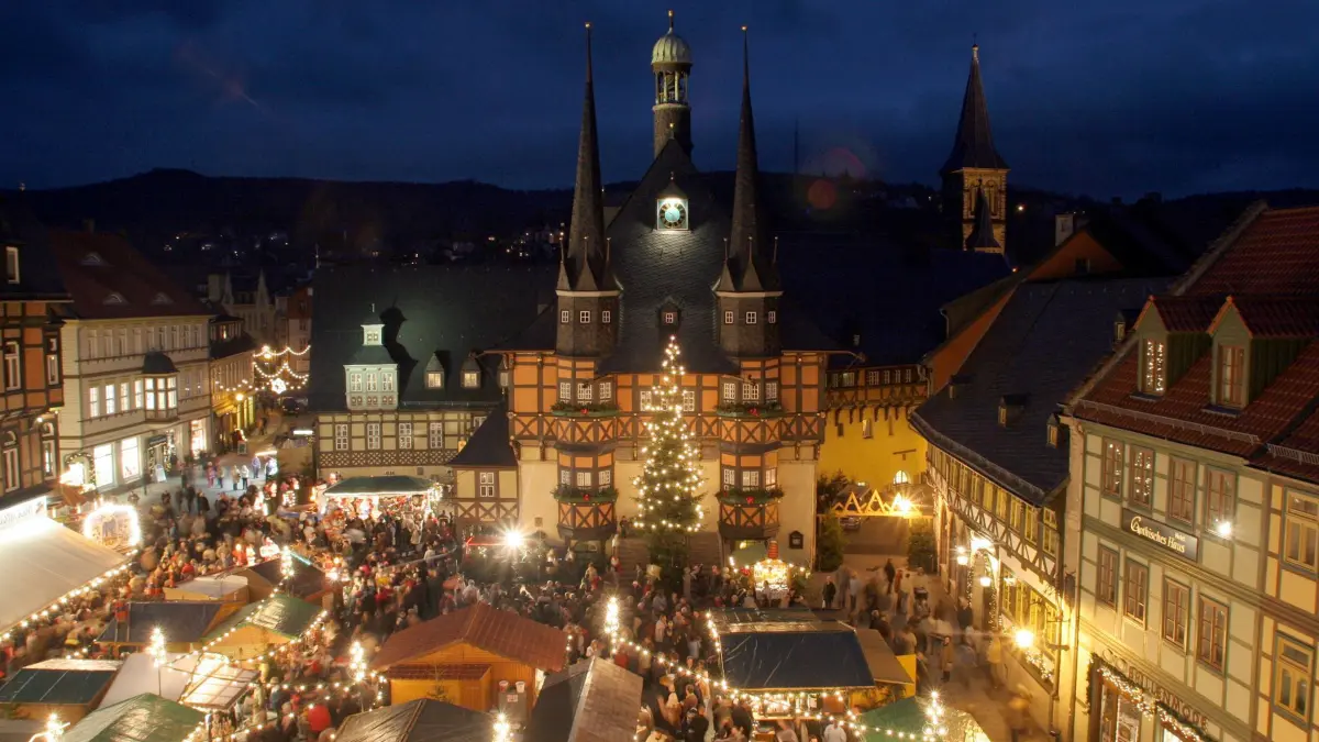 Blick auf das Rathaus und den Weihnachtsmarkt in Wernigerode, aufgenommen am 28.11.2004. In vielen Harzer Fachwerkstädten öffneten am letzten Novemberwochenende die Weihnachtsmärkte. Die romantische Atmospäre vor historischer Kulisse in Wernigerode (Sachsen-Anhalt) lockt jedes Jahr in der Adventszeit tausende Besucher an. Insgesamt bietet der Harz in diesem Jahr 47 Weihnachts- und Wintermärkte. Foto: Matthias Bein/lah +++ dpa-Bildfunk +++
