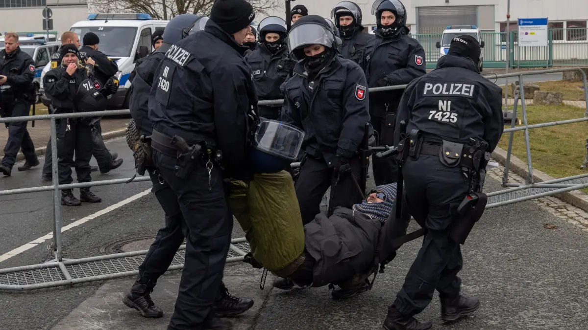 AfD-Parteitag Riesa - Proteste: 11.01.2025, Sachsen, Riesa: Polizisten schaffen Demonstranten von der Straße. Diese wollen den AfD-Parteitag an der WT Energiesysteme Arena Riesa stören. Auf dem Parteitag soll das Bundestagswahlprogramm verabschiedet und die Co-Vorsitzende Weidel als Kanzlerkandidatin aufgestellt werden. Foto: Daniel Wagner/dpa +++ dpa-Bildfunk +++