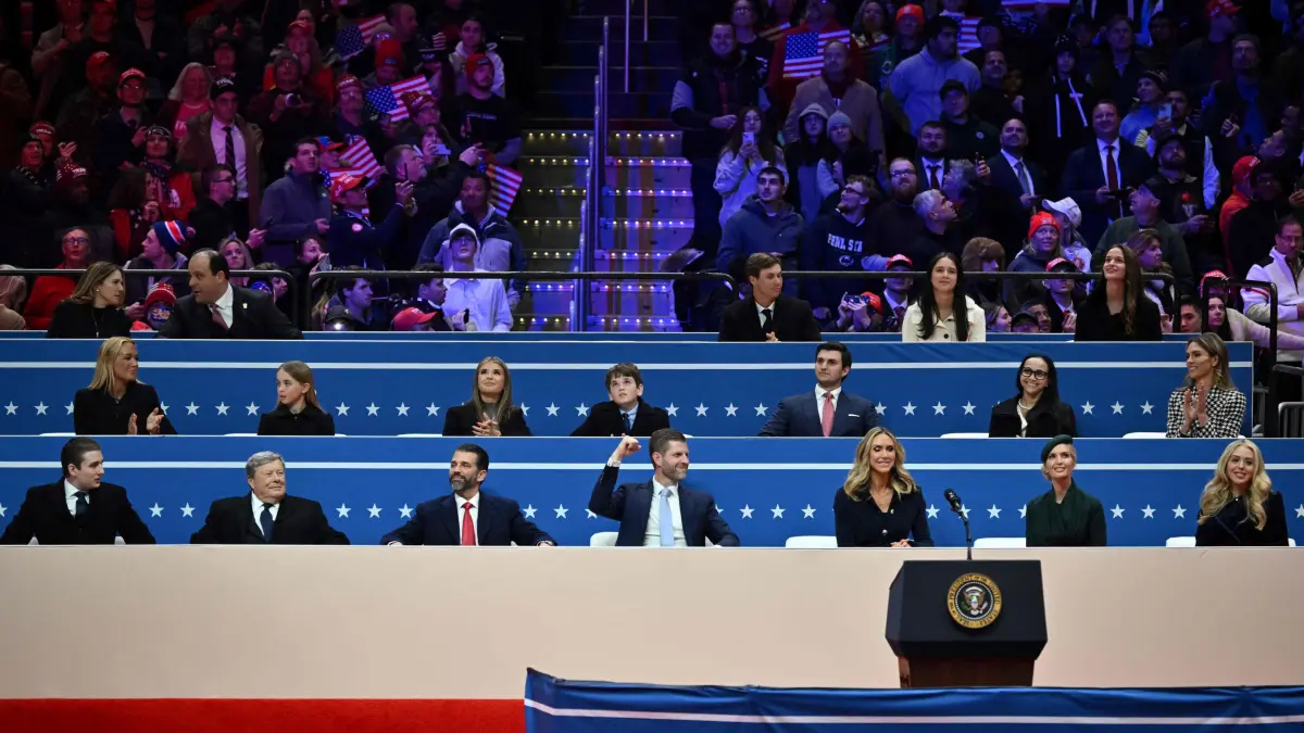 From L to R, Barron Trump, Viktor Knavs, Don Trump, Jr., Eric Trump, Lara Trump, Ivanka Trump and Tiffany Trump wait for US President Donald Trump to speak during the inaugural parade inside Capitol One Arena in Washington, DC, on January 20, 2025. (Photo by ANGELA WEISS / AFP)