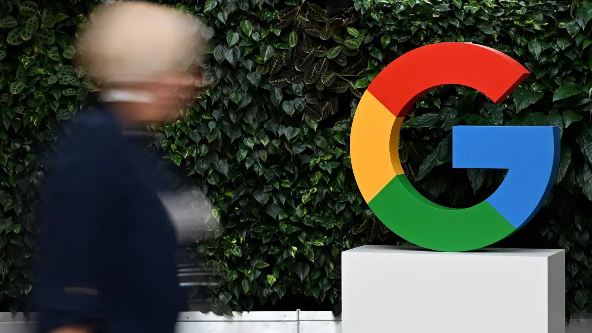 (FILES) A woman walks past a Google logo at the Google Campus in Warsaw on February 13, 2025. Microsoft, Meta, Apple, Uber...: the vast majority of technology used daily by Europeans is American. But in the face of an increasingly unpredictable Donald Trump, there are growing calls for the continent to beef up its technological sovereignty. (Photo by Sergei GAPON / AFP)