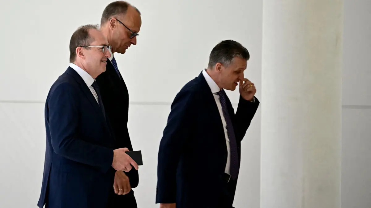(L-R) Designated German Interior Minister Alexander Dobrindt, designated German Chancellor Friedrich Merz and designated Chief of Staff and Minister for Special Tasks Thorsten Frei are pictured during a break of a session at the Bundestag (lower house of parliament), as MPs are to elect Germany's next Chancellor, in Berlin on May 6, 2025. German MPs will vote again on conservative leader Friedrich Merz's bid to become chancellor after he failed to win the necessary votes in the first round. (Photo by Tobias SCHWARZ / AFP)