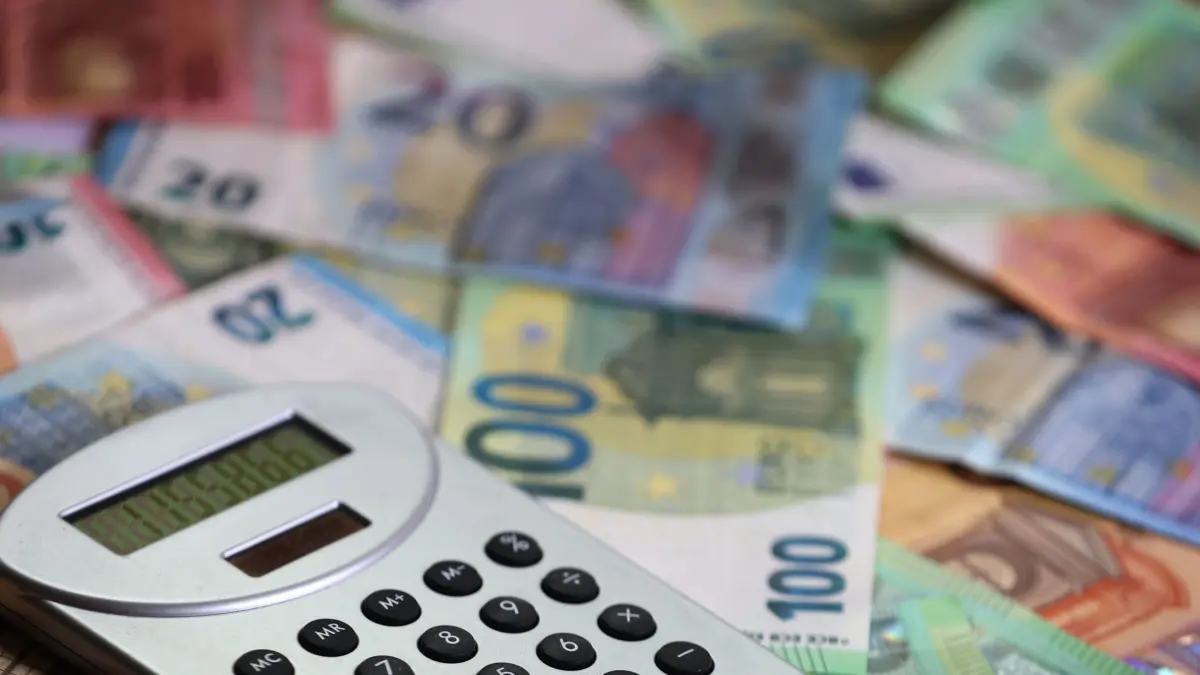 ILLUSTRATION - 15.05.2024, Bayern, Kaufbeuren: ILLUSTRATION: Ein Taschenrechner liegt auf verschiedenen Euro-Banknoten. (zu dpa: «Rechnungshof nennt Finanzlage der Kommunen dramatisch») Foto: Karl-Josef Hildenbrand/dpa +++ dpa-Bildfunk +++