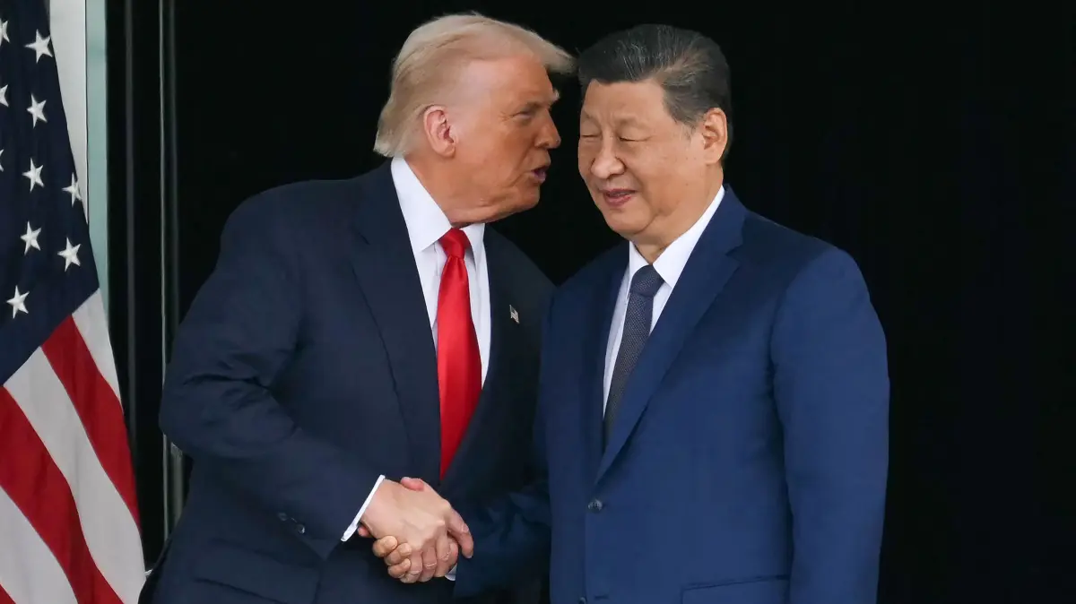 (FILES) US President Donald Trump (L) shake hands with his Chinese counterpart Xi Jinping as they leave after their talks at the Gimhae Air Base, located next to the Gimhae International Airport in Busan on October 30, 2025. Xi held a phone call with Trump on February 4, 2026, Beijing's state media said without immediately providing further details. The call came just after Xi spoke to Russian leader Vladimir Putin in a video call, where the two countries hailed their "stabilising" ties in the face of a turbulent world. (Photo by ANDREW CABALLERO-REYNOLDS / AFP)