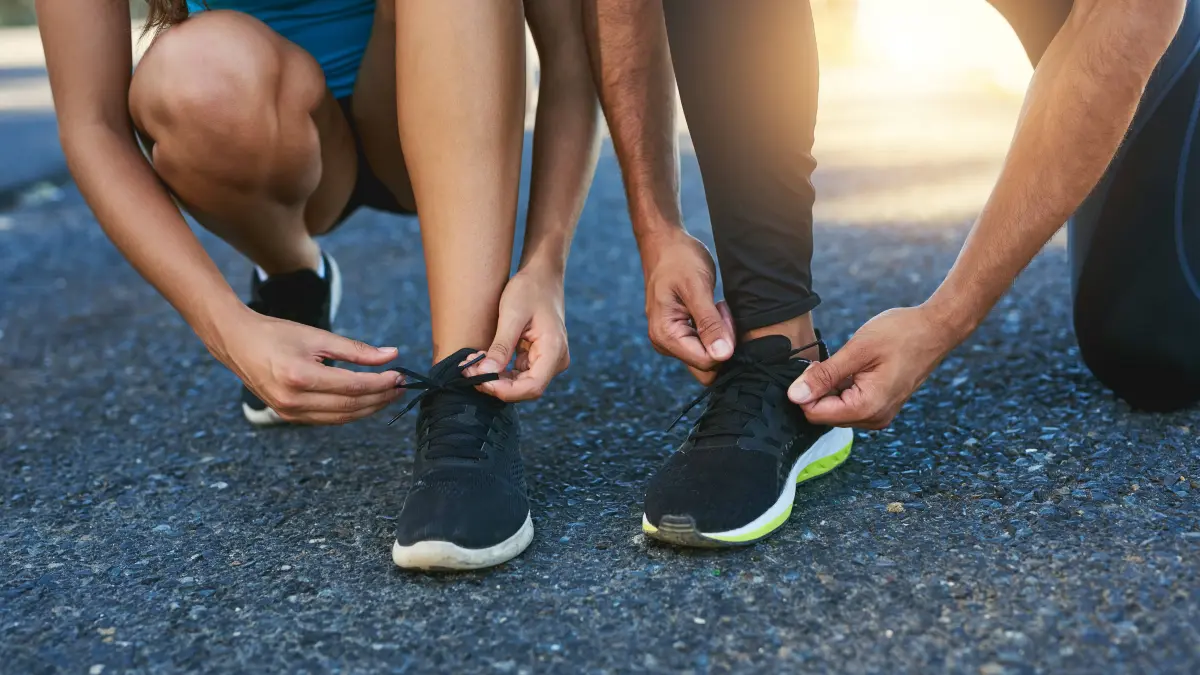 Tie up and hit the road together. a couple tying their shoelaces while out for a run.: Tie up and hit the road together. a couple tying their shoelaces while out for a run LicenseRF 20262259 ,model released, Symbolfoto PUBLICATIONxINxGERxSUIxAUTxONLY Copyright: xZoonar.com/KasperxRavlox 20262259 ,model released, Symbolfoto ,property released