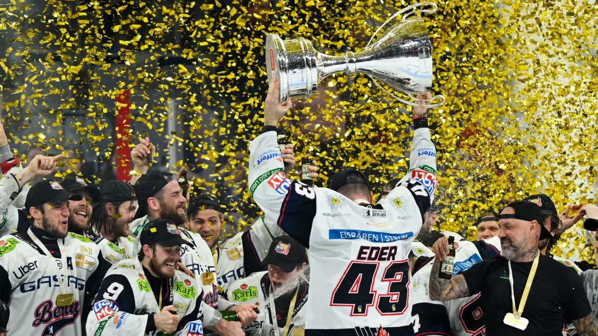 Eisbären Berlin: ARCHIV - 03.05.2026, Baden-Württemberg, Mannheim: Eishockey, Männer: DEL, Adler Mannheim - Eisbären Berlin, Meisterschaftsrunde, Finale, 5. Spieltag, SAP-Arena, Andreas Eder (Eisbären Berlin) bejubelt mit dem Pokal den Gewinn der Deutschen Meisterschaft. Nun wurde ein Stürmer verpflichtet. (zu dpa: «Eisbären verpflichten Stürmer Rihards Griva») Foto: Florian Wiegand/dpa +++ dpa-Bildfunk +++
