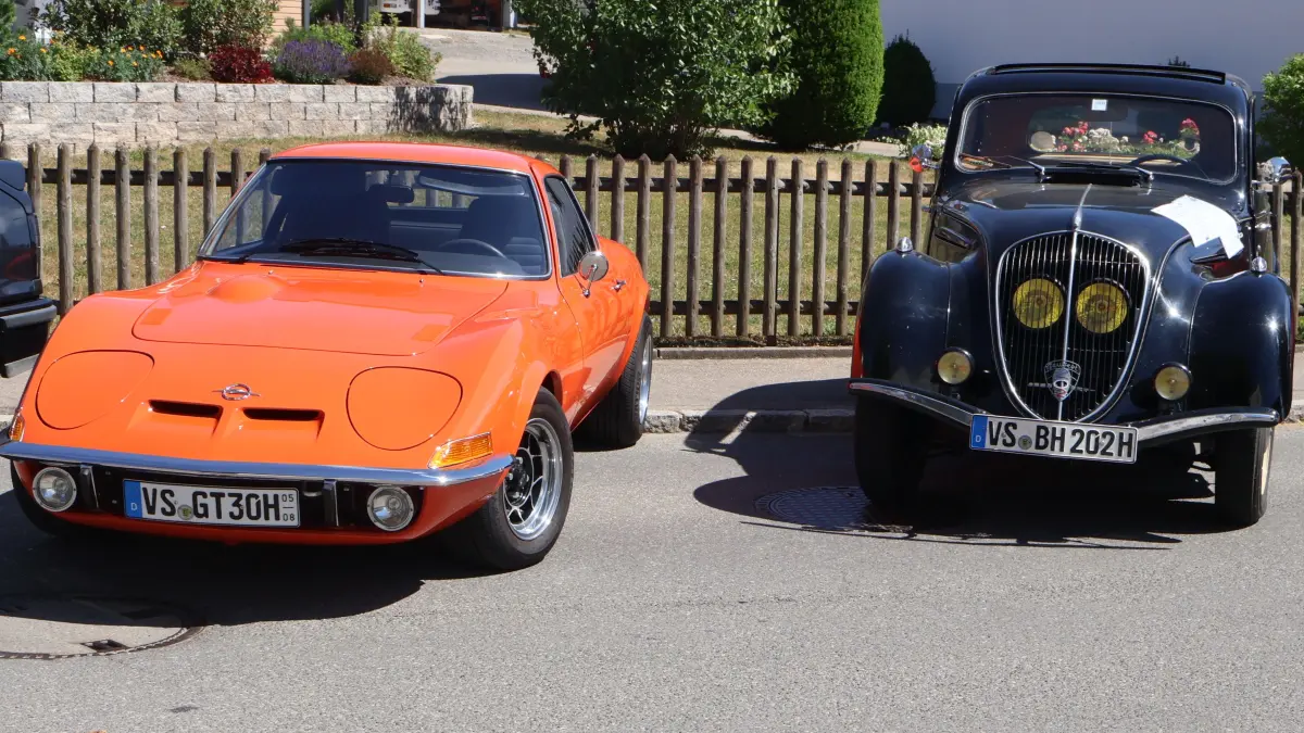 Bild 1: Zwei Hingucker beim Oldtimer Treffen. Der Peugot 202 rechts aus dem Jahre 1948 und der Opel GT aus dem Jahre 1973.