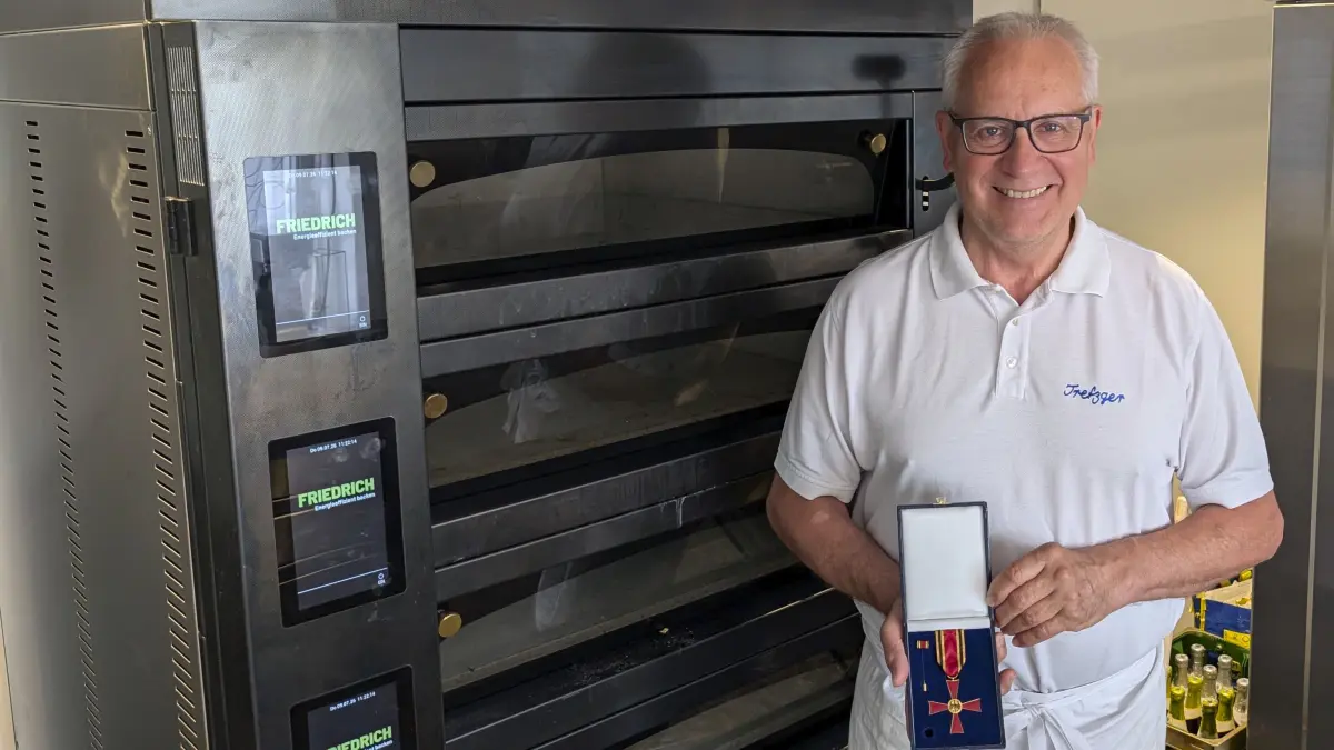 Fritz Trefzger mit dem Bundesverdienstkreuz - und vorm großformatigen Steinbackofen, den er sich für den Ruhestand daheim eingerichtet hat.