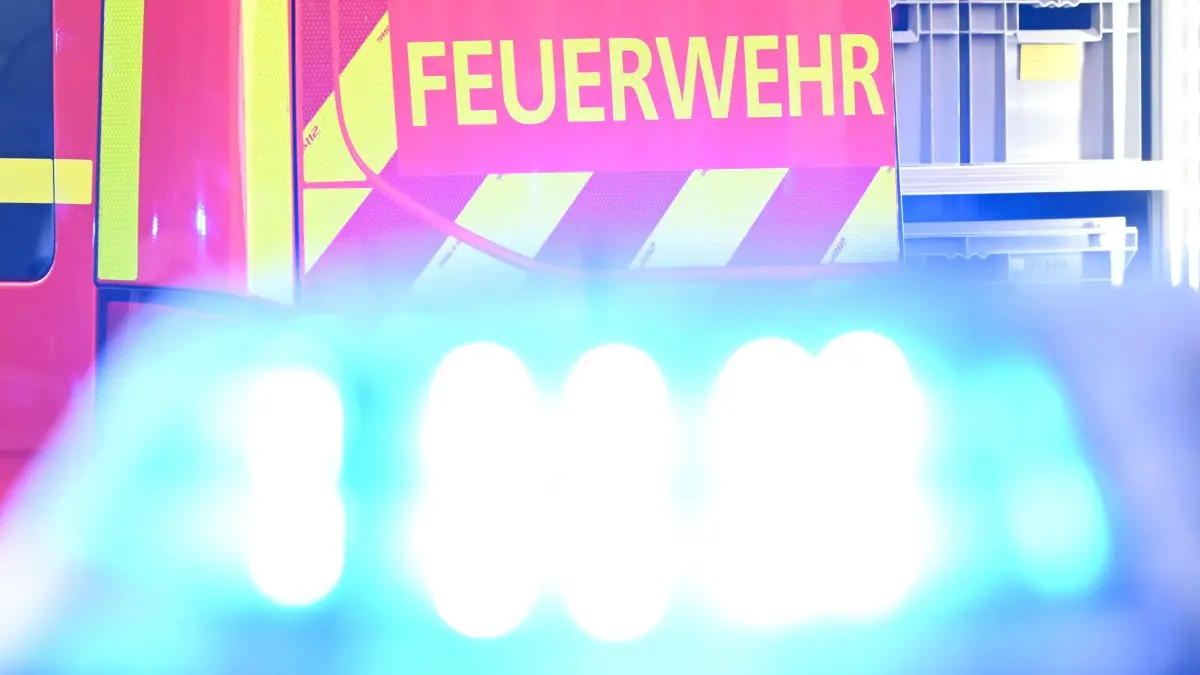 Einsatz: ARCHIV - 02.05.2025, Baden-Württemberg, Stuttgart: Ein Fahrzeug der Feuerwehr steht bei einem Einsatz auf einer Straße, während im Vordergrund das Blaulicht eines Polizeifahrzeugs zu sehen ist. (Symbolfoto) (zu dpa: «A23 nach zwei Unfällen voll gesperrt - ein Verletzter») Foto: Bernd Weißbrod/dpa +++ dpa-Bildfunk +++