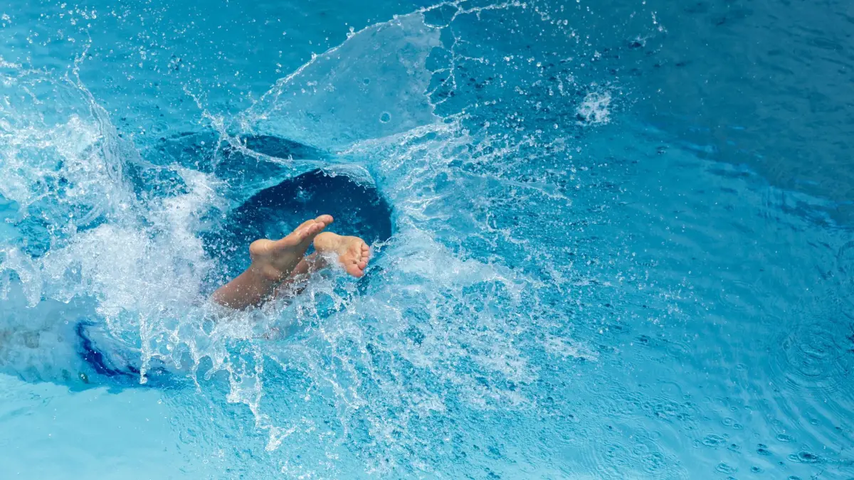 Sprung ins Schwimmbecken: ARCHIV - 26.07.2026, Baden-Württemberg, Sigmaringen: Ein Mann springt in einem Freibad ins Wasserbecken (zu dpa: «Roman «Weiterschwimmen» - Trauer, Trost und Hoffnung im Pool») Foto: Thomas Warnack/dpa +++ dpa-Bildfunk +++