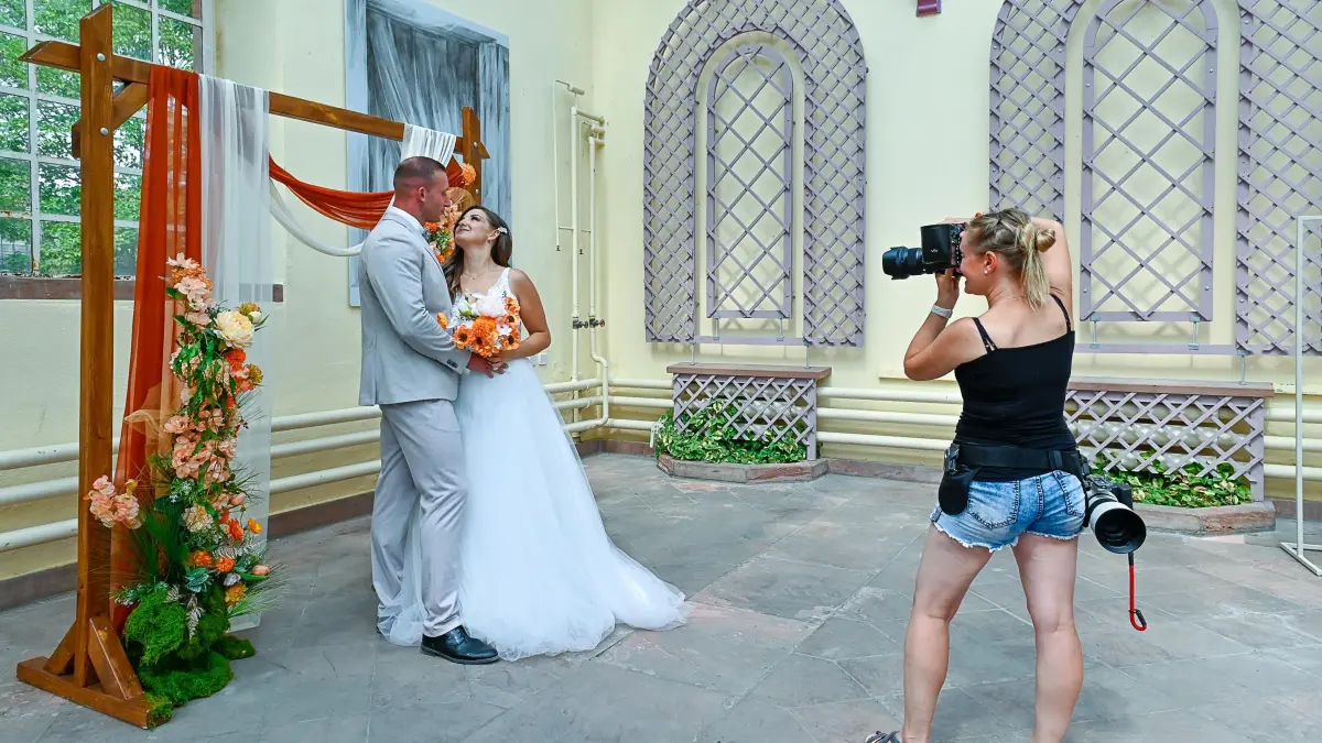 Helene Karsten fotografiert ein Hochzeitspaar in der Orangerie.
