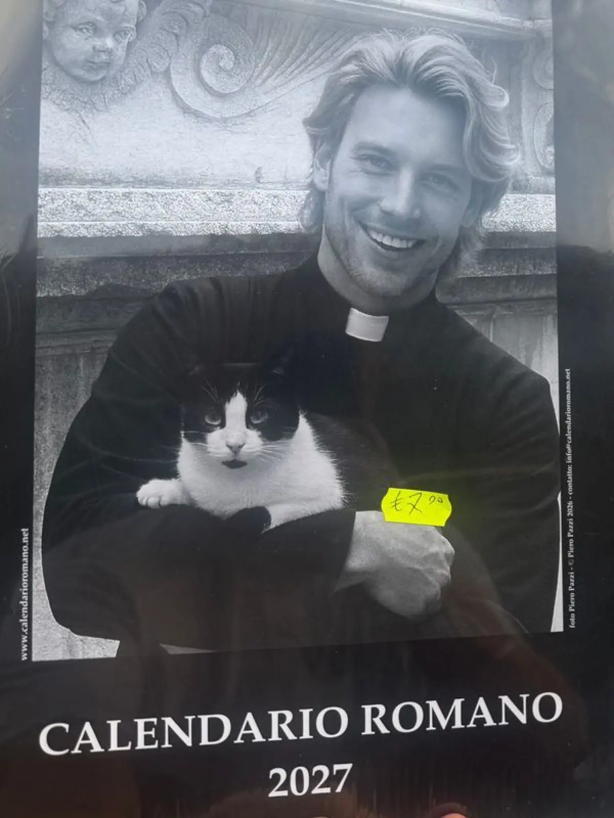 Der neue Mann in Schwarz hat blonde Locken, Drei-Tage-Bart und hält eine Katze im Arm.
