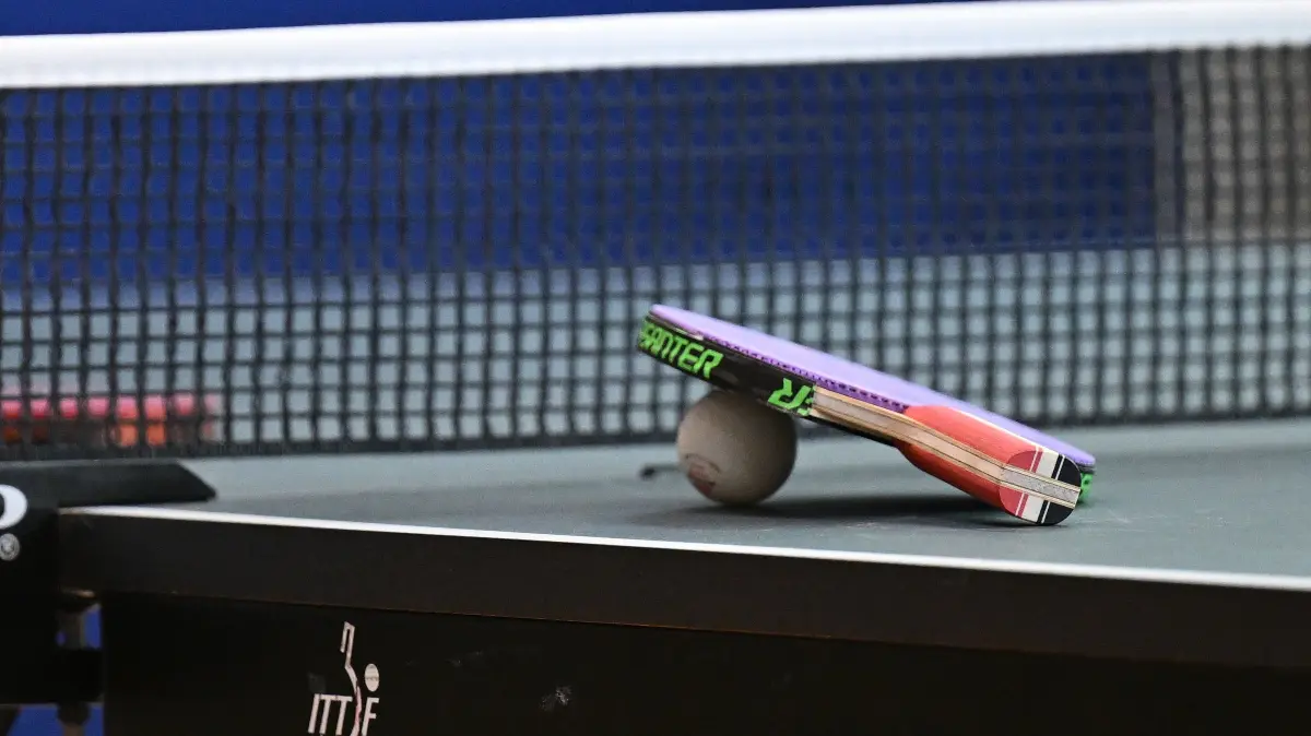 Ein Tischtennisschlaeger mit Ball liegt auf der Tischtennisplatte vor dem Netz
Detailaufnahme, Tischtennis, Sportgeraet, Tischtennisschlaeger, 06.05.2025
Foto: Eibner-Pressefoto/Juergen Augst