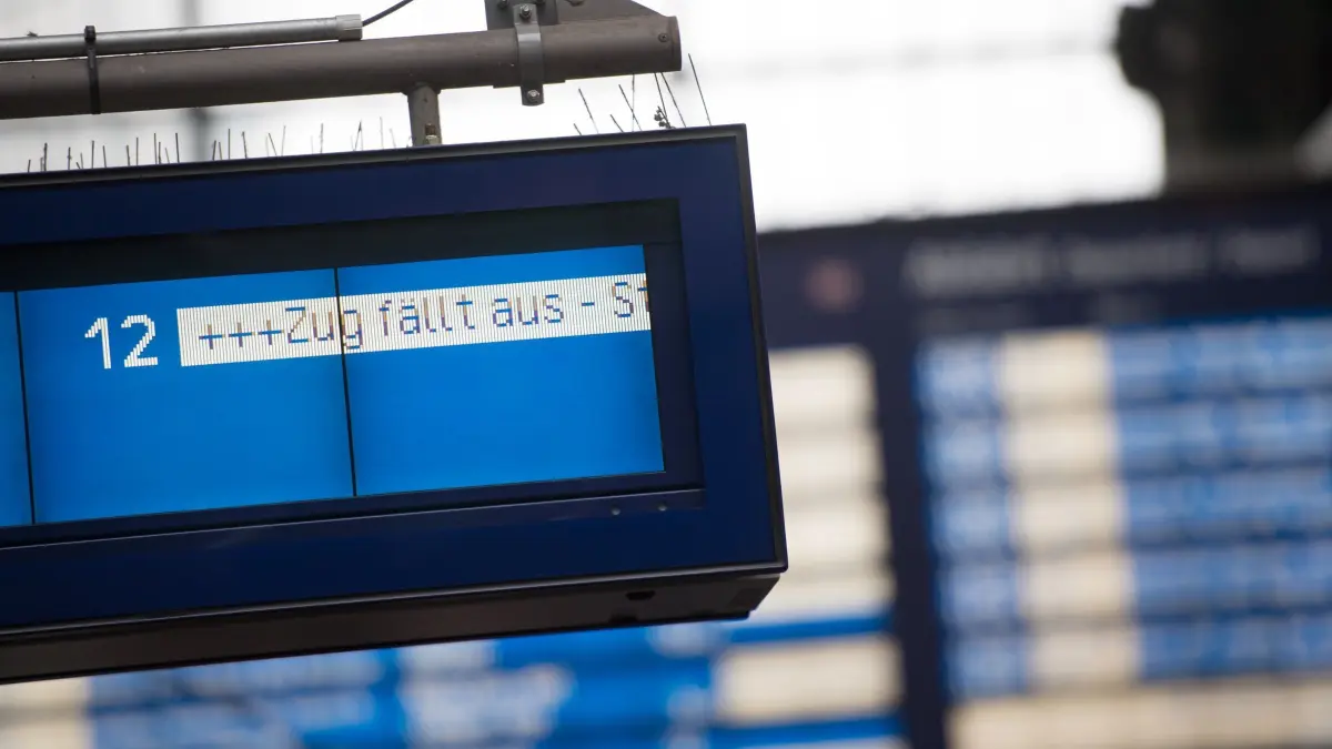 Auf einer Anzeigetafel im Bahnhof steht „Zug fällt aus“