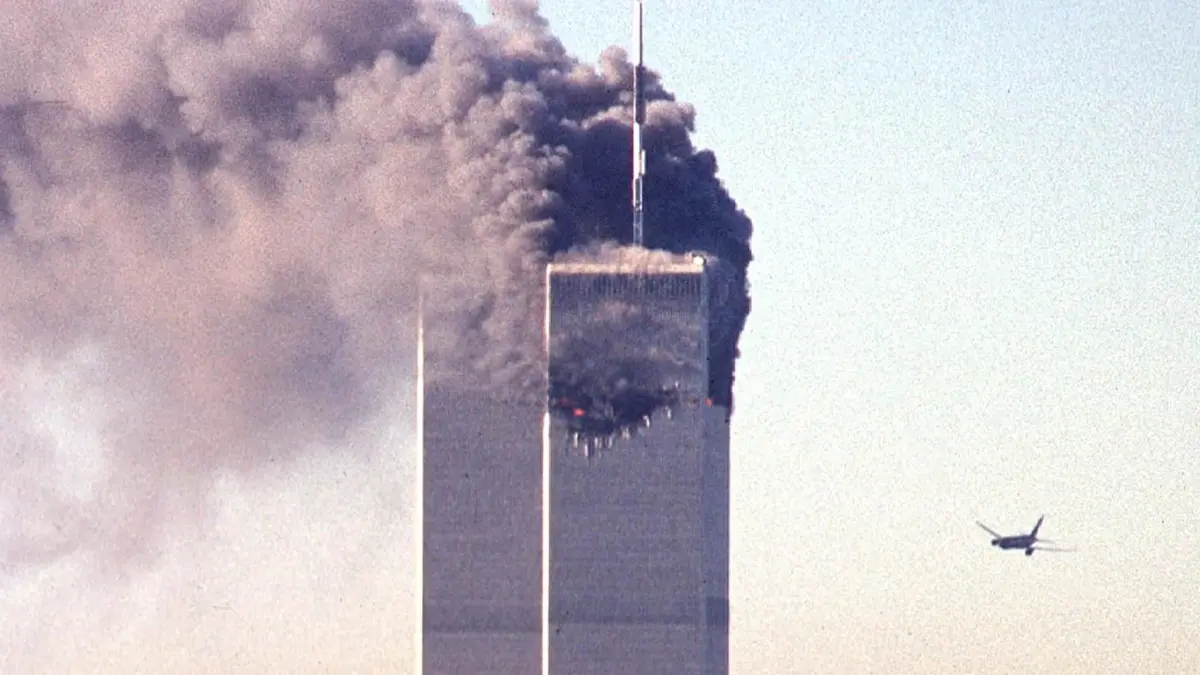FILES-US-ATTACKS-9/11-ANNIVERSARY-EDUCATION: (FILES) In this file photo commercial aircraft United Airlines flight 175 approaches the south tower of the World Trade Center as smoke billows from the north tower in lower Manhattan, New York on September 11, 2001. When 17-year-old student Max Avena visited the site of New York's fallen Twin Towers, hearing the first-hand accounts of survivors of the deadliest attacks on US soil left him "speechless." (Photo by SETH MCALLISTER / AFP)