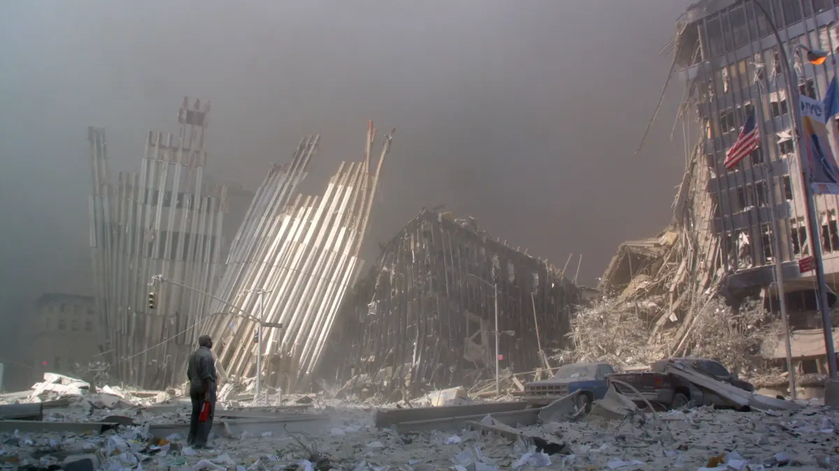 FILES-US-ATTACKS-9/11-ANNIVERSARY: (FILES) This September 11, 2001 file photo shows a man standing in the rubble, and calling out asking if anyone needs help, after the collapse of the first World Trade Center Tower in New York City. September 11, 2026, will mark the 25th anniversary of the September 11, 2001, attacks that killed nearly 3,000 people in New York, Washington and Pennsylvania. (Photo by DOUG KANTER / AFP)