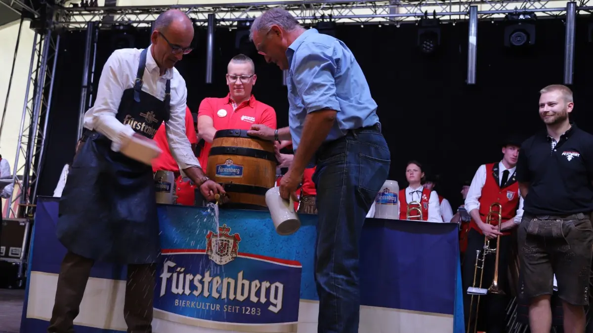 Sitzt: Mit dem zweiten Schlag schafft es Bürgermeister Jörg Frey, den Zapfhahn bombenfest im Fass zu versenken, sodass er dann gemeinsam mit Artur Welte , dem Vertreter der Brauerei, Freibier ausschenken kann. Kommandant Georg Schilli (dazwischen) und der neue Festwirt Robin Hansmann (rechts) beobachten das Geschehen genau.