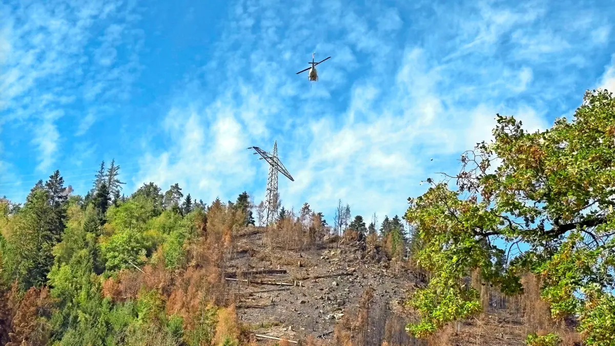 Oberhalb des Steilhangs kreist der Hubschrauber.