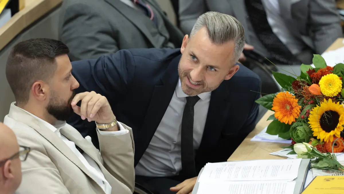 GERMANY-POLITICS-VOTE-STATE-PARLIAMENT: The main candidate of the far-right Alternative for Germany (AfD) party in the Saxony-Anhalt state election Ulrich Siegmund (R) talks with Tobias Rausch of the far-right Alternative for Germany (AfD) party after he was elected president of the parliament during a session at the State Parliament in Magdeburg, eastern Germany on October 6, 2026, as the state parliament of Saxony-Anhalt convenes for the first time since the state elections. Newly elected state lawmakers will gather for the first time in the parliament building in the state capital Magdeburg to elect a speaker, with a candidate of the far-right Alternative for Germany (AfD) expected to win. The AfD is poised to preside over a state assembly for the first time following its landslide election victory in the eastern state of Saxony-Anhalt. The AfD took nearly 44 percent of the vote in the September 2026 state election. (Photo by Ronny HARTMANN / AFP)