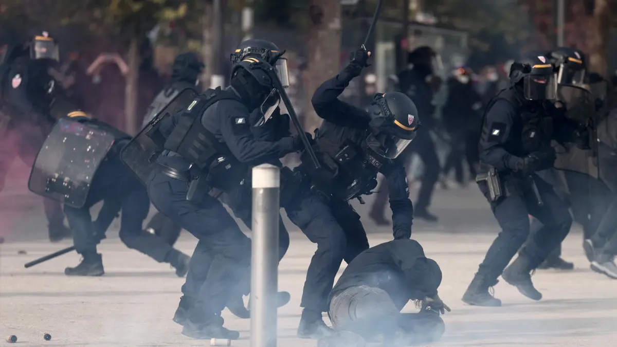 Proteste in Marseille: 24.10.2026, Frankreich, Marseille: Ein Beamter des französischen Republikanischen Sicherheitskorps (CRS – Compagnies Républicaines de Sécurité) schlägt einen Demonstranten mit einem Schlagstock während einer Demonstration für Kaufkraft, den Erhalt öffentlicher Dienstleistungen sowie steuerliche und soziale Gerechtigkeit im Rahmen eines landesweiten Mobilisierungsaufrufs, der ehemalige Mitglieder der „Gelbwesten“-Bewegung, Gewerkschaften sowie Schüler und Studenten zusammenbrachte. Foto: Thibaud Moritz/AFP/dpa +++ dpa-Bildfunk +++
