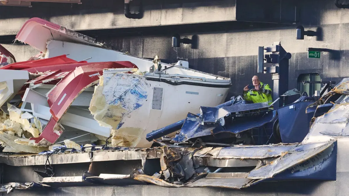 Kreuzfahrtschiff stößt mit Containerschiffen zusammen: Zwei Männer begutachten den Schaden an der «Mein Schiff 3». Das Kreuzfahrtschiff war am Vortag bei stürmischem Wetter mit zwei Containerschiffen kollidiert. (zu dpa: «Tui sagt Reise der «Mein Schiff 3» nach Unfall ab»)