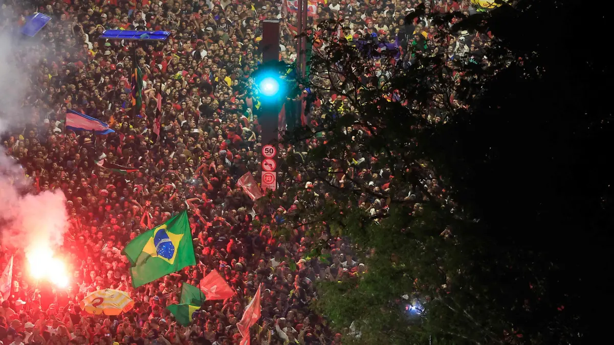BRAZIL-ELECTION-RUNOFF-VOTE: Supporters of Brazil's President and re-election candidate for the Workers' Party (PT) Luiz Inacio Lula da Silva celebrate after the presidential runoff election in Sao Paulo, Brazil, on October 25, 2026. Lula da Silva pulled off a dramatic comeback on October 25, 2026, as he clinched election victory against right-wing senator Flavio Bolsonaro, who trounced him in the first round. (Photo by Miguel SCHINCARIOL / AFP)
